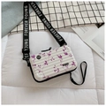 Close-up of white hardshell mini suitcase bag with purple floral print and wide strap - White with Purple Flowers