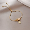 Detail of adjustable gold heart bracelet with sparkling zircon cylinder and hollow beads - Gold
