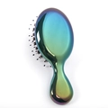 Detail of the holographic rainbow gradient finish on a portable plastic hairbrush surface - Bristle Teeth / Iridescent Electroplated Green