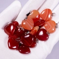 Polished heart-shaped natural agate pendants in dark red and orange red hues - Red Agate