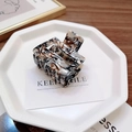 Detail of marble pattern square hair claw clip on a decorative white display tray - 5.2cm / Patterned Coffee
