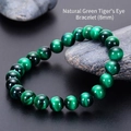 Detail of 8mm natural green tiger eye stone beads with silky luster on dark stone - Green Tiger Eye Bracelet (8mm)