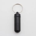 Mini black aluminum alloy waterproof pill box keychain with capsule shape and matte finish - Black