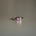 Detail of silver adjustable open ring featuring a glowing pink heart-shaped center - Adjustable Open / Heart / Pink