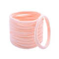 Macro shot of seamless pink nylon hair ties showing high elasticity and soft texture - Light Pink