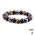 Macro detail of 8mm tiger eye, obsidian and hematite beads on a stretch bracelet - 17cm / 8mm Triple Tiger Eye Obsidian Hematite