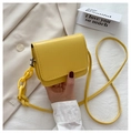 Detailed view of yellow mini crossbody bag with thick acrylic chain held by hand - Small / Yellow