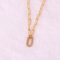 Interlocked gold-plated chain necklace with a rectangular diamond-set pendant on pink paper - Oval Gold Necklace