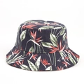 Close-up of black cotton bucket hat featuring colorful tropical leaf patterns and textures - Navy Blue