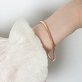 Polished minimalist rose gold round bangle bracelet for women in a classic slender design - Rose Gold / M