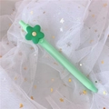 Green retractable gel pen with creative flower topper on white starry mesh background - 0.5mm / Green Flower (Colorful Barrel)