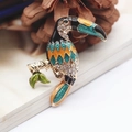 Detailed view of the toucan brooch with colorful enamel and sparkling rhinestones - Toucan