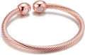 Macro detail of rose gold twisted cable cuff bracelet with magnetic round metal ends - Rose Gold