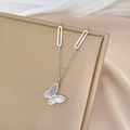 Macro view of silver titanium necklace with white mother of pearl butterfly pendant - Silver