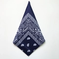 Detail of navy blue paisley bandana folded in diamond shape on white background - Navy Blue