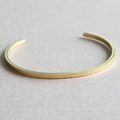 Minimalist gold stainless steel C-shaped cuff bracelet with a brushed matte finish - Glossy