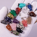 Various natural stone angel pendants in rose quartz and amethyst held in hand - Multicolor