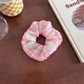 Pink and green plaid scrunchie with a seersucker texture on a rustic wooden table - Colorful Pink