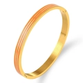 Detail of gold titanium steel bangle showing orange enamel stripes and buckle closure - Gold Orange