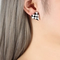 Chic heart-shaped stud earring with black and white checkerboard pattern on model - Steel Heart (F758)