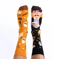 Detailed view of asymmetric novelty socks featuring yellow pattern and black portrait design - Gentleman Life