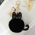 Schwarzer Plüsch-Katzen-Bommel Anhänger mit goldenem Metallring und Lederohren - Schwarz