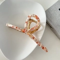 Detail of 13cm oversized marble orange acetate hair claw clip on minimalist ceramic tray - Sakura Pink