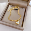 Golden stainless steel bead bracelet featuring a white shell heart pendant in a gift box - Titanium Steel/Mother of Pearl / Gold (N515 Gold)