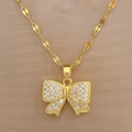Macro shot of gold bow tie pendant necklace with shimmering white crystal inlay - Gold Bow Style (E403) / Gold