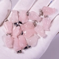 Pink rose quartz angel pendants with metal clasp held in hand for jewelry making - Rose Quartz