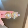 Long vintage drop earrings featuring golden spiral design and round pearl inlay - Golden Spiral Pearl Studs