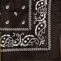 Close-up of black paisley pattern on polyester bandana fabric texture and details - Coffee