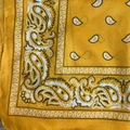 Detailed close-up showing the yellow paisley pattern and woven texture of the bandana - Gold