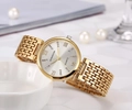 Detailed view of women's gold steel watch with crystal markers on white ceramic - All Gold White Face