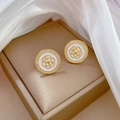 Macro view of gold flower earrings with white inlay and sparkling crystals on satin - Camellia Round Stud Earrings (D426)