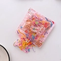Macro view of macaron colored elastic hair ties in cute cartoon bear packaging - Multicolor