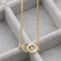 Golden micro-paved zircon double ring pendant necklace on a premium gray velvet box - Gold (Rainbow Zirconia)