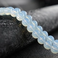 DIY jewelry making supplies featuring round translucent white glass beads with opal luster - Opal White