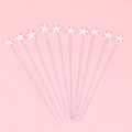 Set of 10 white star cake toppers with silver metal wires on a pink background - Large White Star - 10 Pack