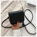 Close-up of black mini flap crossbody bag with acrylic chain and smooth faux leather texture - Small / Black
