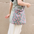 Detail of green corduroy tote bag with pink floral patterns worn as a shoulder bag - Corduroy Cherry Blossom