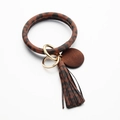 Detail of leopard print leather wristlet keychain with fringe tassel and wood pendant - Coffee Leopard