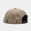 Detail view of khaki miki hat with leaf metal badge and brown leather strap back - Khaki With Letter Maple
