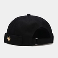 Detail of docker hat with golden leaf metal emblem and adjustable strap on back - Black With Metal Maple