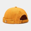 Detail of yellow brimless docker hat with metal leaf accent and adjustable velcro strap - Yellow With Metal Maple