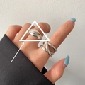 Minimalist silver interlocking crossover ring with polished finish on model hand - Smooth Croissant/Triple Layer Intertwined