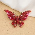 Exquisite golden butterfly brooch featuring vibrant red and pink crystals in a vintage style - Style 63/Ancient Gold Red Series