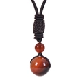 Detailed macro of 20mm red agate bead and black handmade woven cord on the necklace - Dream Agate