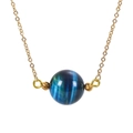 Macro detail of 16mm blue tiger eye stone pendant with gold chain showing cat eye effect - Blue
