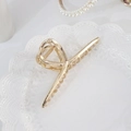 Elegant gold alloy shark hair claw clip with twisted loop design on a white ceramic plate - 59# Large Metal Cross Claw Clip / Large